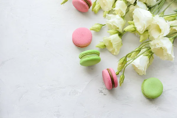 stock image Eustoma and macaroon on a light background. Delicate composition, postcard, congratulations, good morning. Delicious dessert.