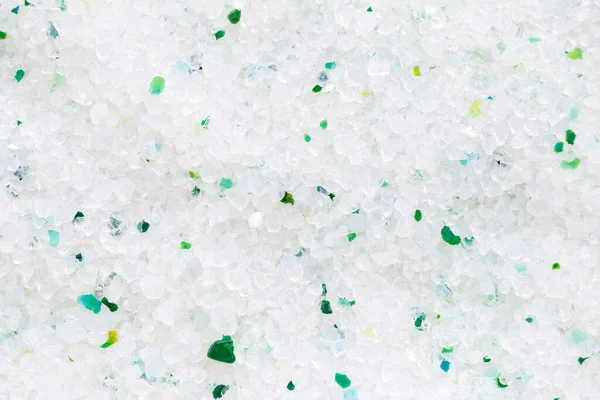 Silica gel white with green crystals for cat litter, close-up. Abstract background of pure silica gel crystals. Natural pet litter. Animal care.