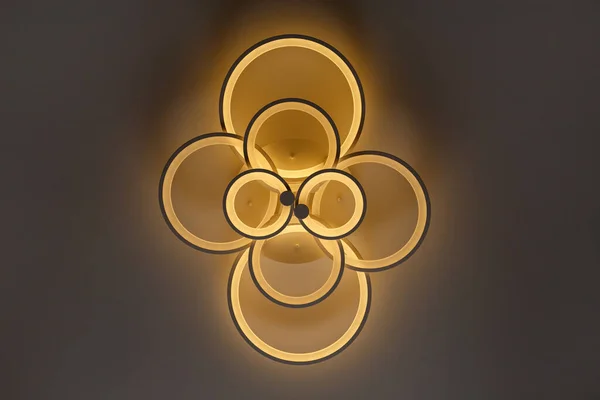 Luminous modern LED ring lamp on the ceiling. Bottom view.