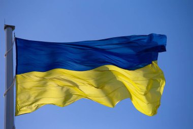 Flag of ukraine against the blue sky close-up. National pride and symbol of the country Ukraine. War in Ukraine. Yellow-blue flag.
