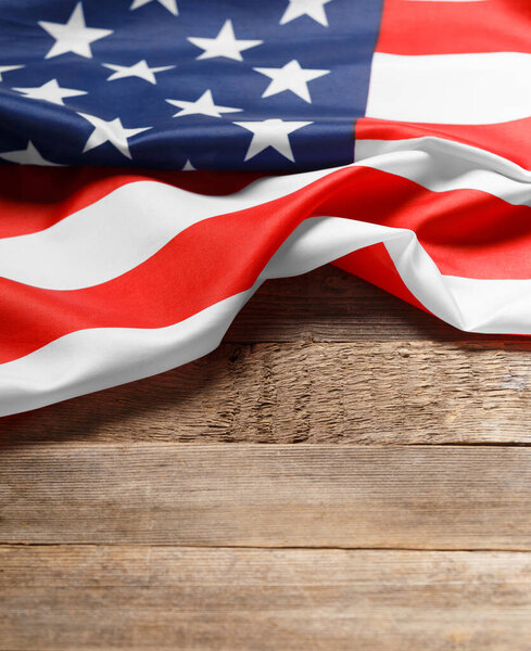Stars and stripes american flag on rustic wooden background, copy space. The pride of the American people. Symbol of independence, freedom and patriotism in the USA