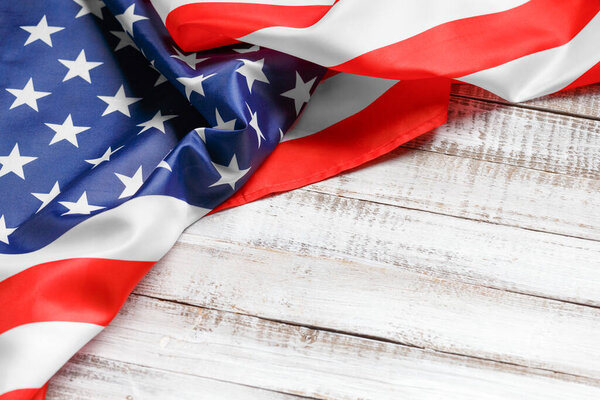 Stars and stripes american flag on rustic wooden background, top view, copy space. The pride of the American people. Symbol of independence, freedom and patriotism in the USA