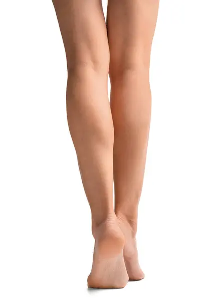 细长的女性腿在白色的背景后视镜 女人的脚被隔离了足部皮肤护理 图库照片