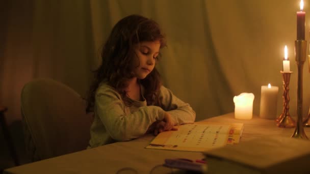 Little Girl Learns Alphabet Candlelight Home Light — Stock Video