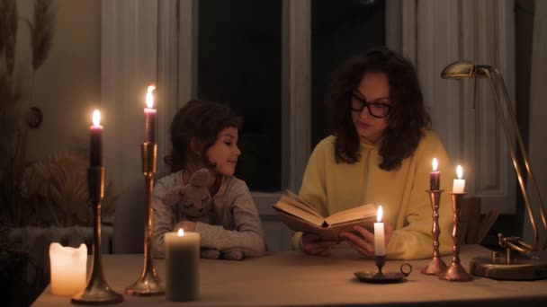 Mom Reads Book Her Daughter Dark Apartment Electricity Candlelight — Stock Video