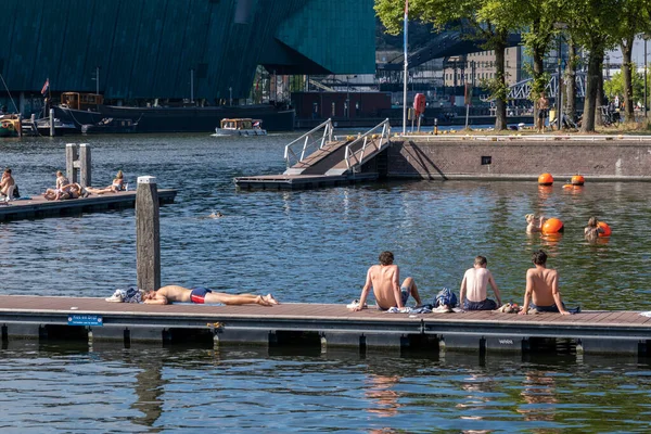 stock image Amsterdam, The Netherlands - 6 September 2022: People bathing at the Marineterrein's inner harbour