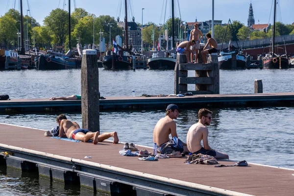 Stock image Amsterdam, The Netherlands - 6 September 2022: People bathing at the Marineterrein's inner harbour