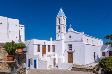 A traditional whitewashed church with blue domes located in the village of Volax, Tinos, Greece clipart