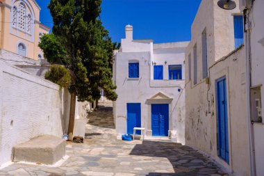 Pyrgos, GR - 6 Ağustos 2023: Beyaz ve mavi evleri olan geleneksel bir Yunan köyünde sokak