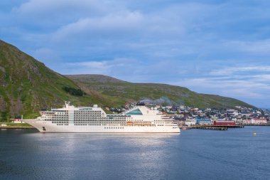 Honningsvag, Norway - 15 July 2023: Seabourn Ovation cruise ship in Honningsvag village in the north of Norway clipart