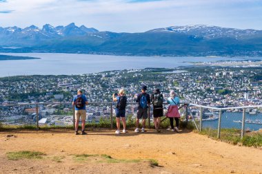 Tromso, Norway - 16 July 2023 : Tourists looking at the view over Tromso from the top of Storsteinen mountain clipart
