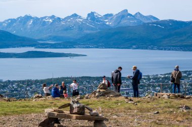 Tromso, Norway - 16 July 2023 : Tourists looking at the view over Tromso from the top of Storsteinen mountain clipart