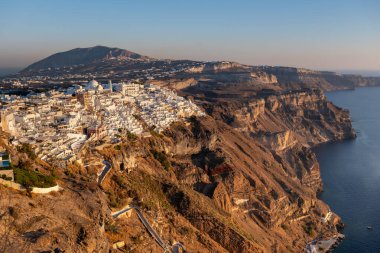 Santorini, GR - 26 September 2024: Fira village at sunset at the beginning of sismic activity and volcanic unrest clipart