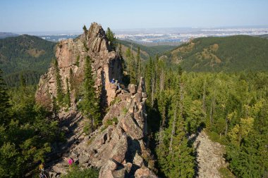 Krasnoyarsk Stolby National Park, Siberia Russia. Chinese Wall rock, point of scenic interest, recreation site for tourists to relax and training of rock climbers and mountaineers. Kitayskaya Stenka clipart