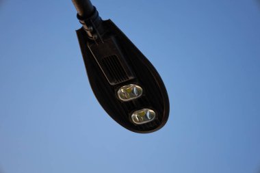 Modern street lighting with two LEDs, urban development, city park  clipart