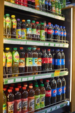 Plastik gazoz şişeleri ve soğuk çay farklı markalar. Coca Cola, Pepsi, Lipton, Fuze. Dükkan rafı, geniş seçim, meşrubat başyazısı, popüler karbonatlı içecekler. Bishkek, Kırgızistan - 26 Mayıs 2023