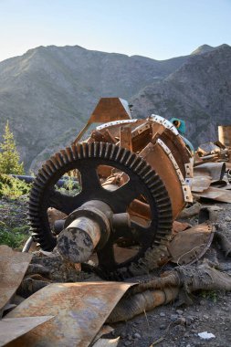 Dökülen malzemeler ve döküntülerle üst üste yığılmış paslı endüstriyel metal yığını..