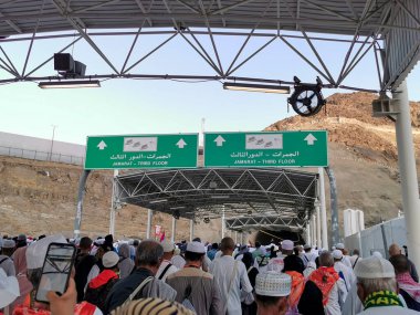 JUNE 29, 2023 - MINA, KINGDOM OF SAUDI ARABIA (KSA) : Asian hajj pilgrims mostly Indonesians and Malaysians walk on to stoning the devils (jamarat) complex in Mina, Saudi Arabia. clipart