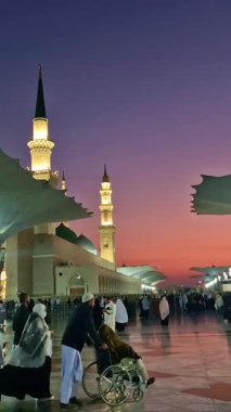 MEDINA, SAUDI ARABIA-JANUARY 30, 2025: Suudi Arabistan Krallığı El Madinah 'ta sabahın erken saatlerinde gün doğumunun ardından Nabawi camisinin yerleşkesindeki Müslüman hacıların dikey görüntüsü. 