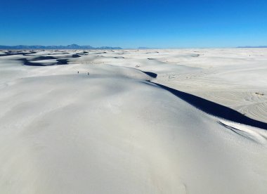 Tourists on white sands - White Sands National Park, New Mexico clipart
