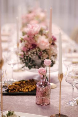 Restorandaki bateride buketlerin içinde güzel pembe çiçekler. Kutlama için zarif bir dekorasyon..