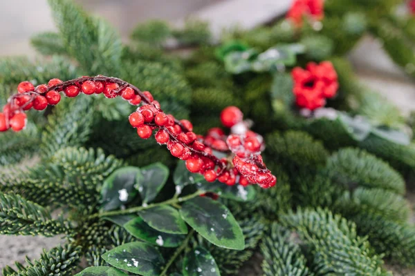 Stock image Macro photo of steaming cast iron hot tub with spa in winter with snow and decorated candles. Christmas twigs with guelder rose and pine cones.