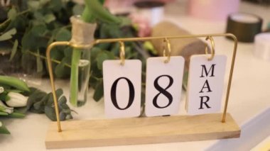 Eight march on calendar in flower shop. Preparing for holiday. Womans day.