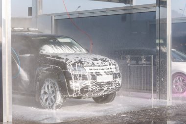 Process of cleaning car with a jet sprayer. Self service car washing.