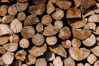 Close-up of chopped firewood. Firewood stacked and prepared. Natural wooden backgroun.