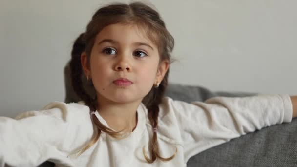 Adorable Little Girl Sits Sofa Watching Home Cute Girl Eating — Stock videók