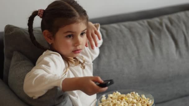 Cute Little Girl Using Remote Controller Watching Cartoons Four Year — Video Stock