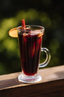 Hot mulled wine in a glass with chopped fruits and star anise and cinnamon. High quality photo