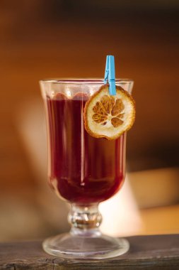 Red tea in a heat-resistant glass with a slice of dried orange. High quality photo