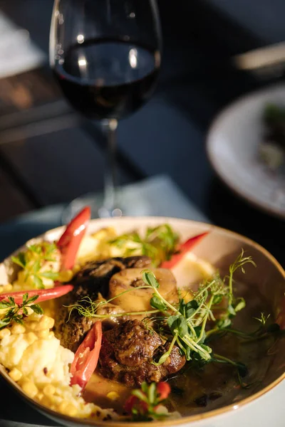 stock image Roasted succulent pork fore shank with vegetables. Knuckle with glass of red wine. High quality photo