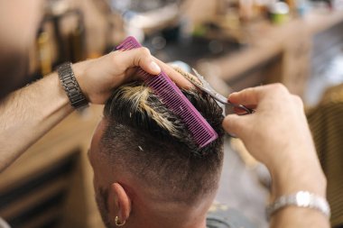 Berber makas kullanıyor ve saç stili yapıyor. Modern berber dükkanı. Yüksek kalite fotoğraf