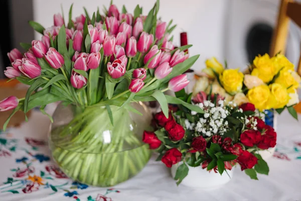 Different bouquets of flowers at home. Present for 8 March. Womans day. Home mood. High quality photo