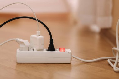 Cable connector for overloaded power boards. Close up focus at a plug foreground.