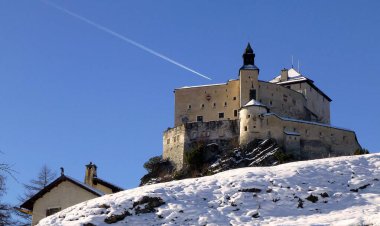 Beautiful view of the majestic medieval castle Tarasp, towering on a hill, is the main attraction of the region of Lower Engadin, canton Graubuden, Switzerland clipart