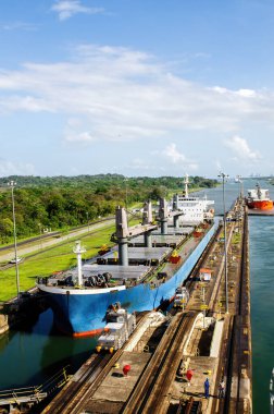 Two cargo ship transiting the Miraflores locks in the Panama Canal in Central America clipart