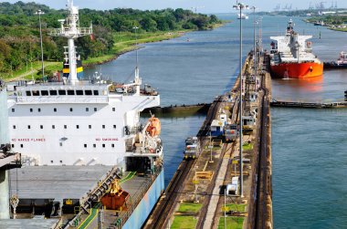 Two cargo ship transiting the Miraflores locks in the Panama Canal in Central America clipart