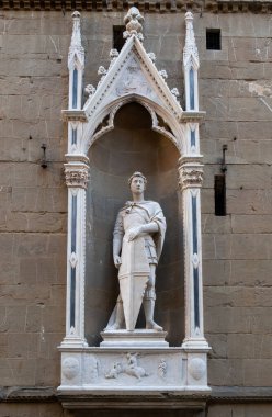 The statue of Saint George the Warrior 1416-1417 by Donatello in the external niches of the church of Orsanmichele in Florence, Italy. clipart