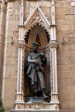 The statue of Saint Luke 1597-1602 by Giambologna in the external niches of the church of Orsanmichele in Florence, Italy. clipart