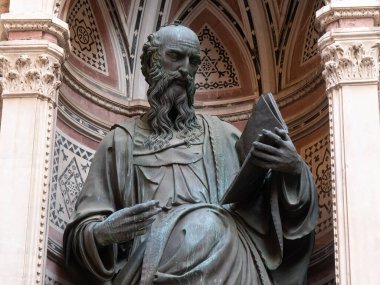 The bronze statue of St. John the Evangelist from the year 1515 by Baccio da Montelupo in the external niches of the church of Orsanmichele in Florence, Italy. clipart