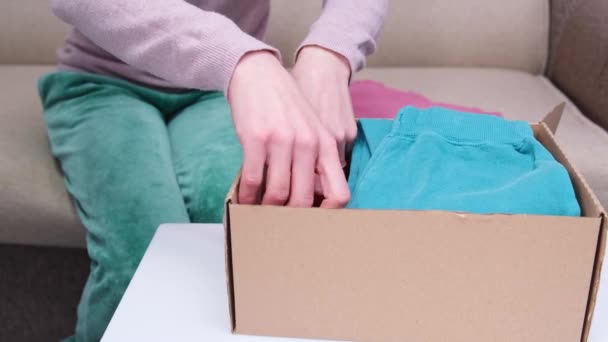 Clothes Donation Packing Cardboard Box Top View Packing Second Hand — Vídeos de Stock