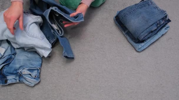 Woman Hands Folding Jeans Pants Clothes Putting Together Order Concept — Vídeos de Stock