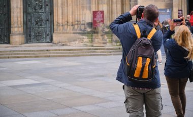 tourists digital camera trying to take travel photo ancient architecture . High quality photo