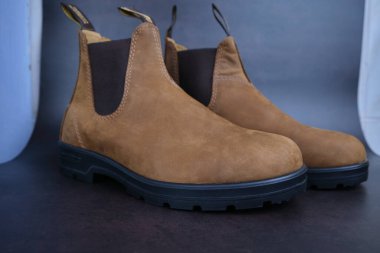 Pair of brown leather Chelsea boots Shoes, chelsea leather boots for men. Male winter, autumn or spring fashion. Footwear on black background