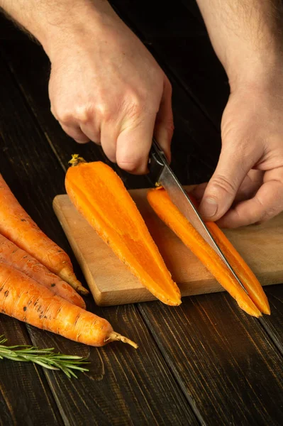 Chef Cuts Fresh Carrots Wooden Cutting Board Close Cook Hands — Stock Photo, Image