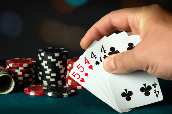Poker cards with a full house or full boat combination in the player hand. Winning combination in a game in a poker club. The concept of fortune in a poker game