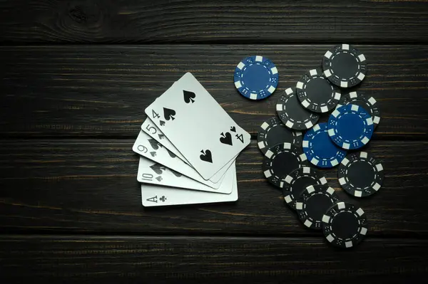 A popular poker game with a winning combination of high card. Cards with chips on a black vintage table in a poker club.